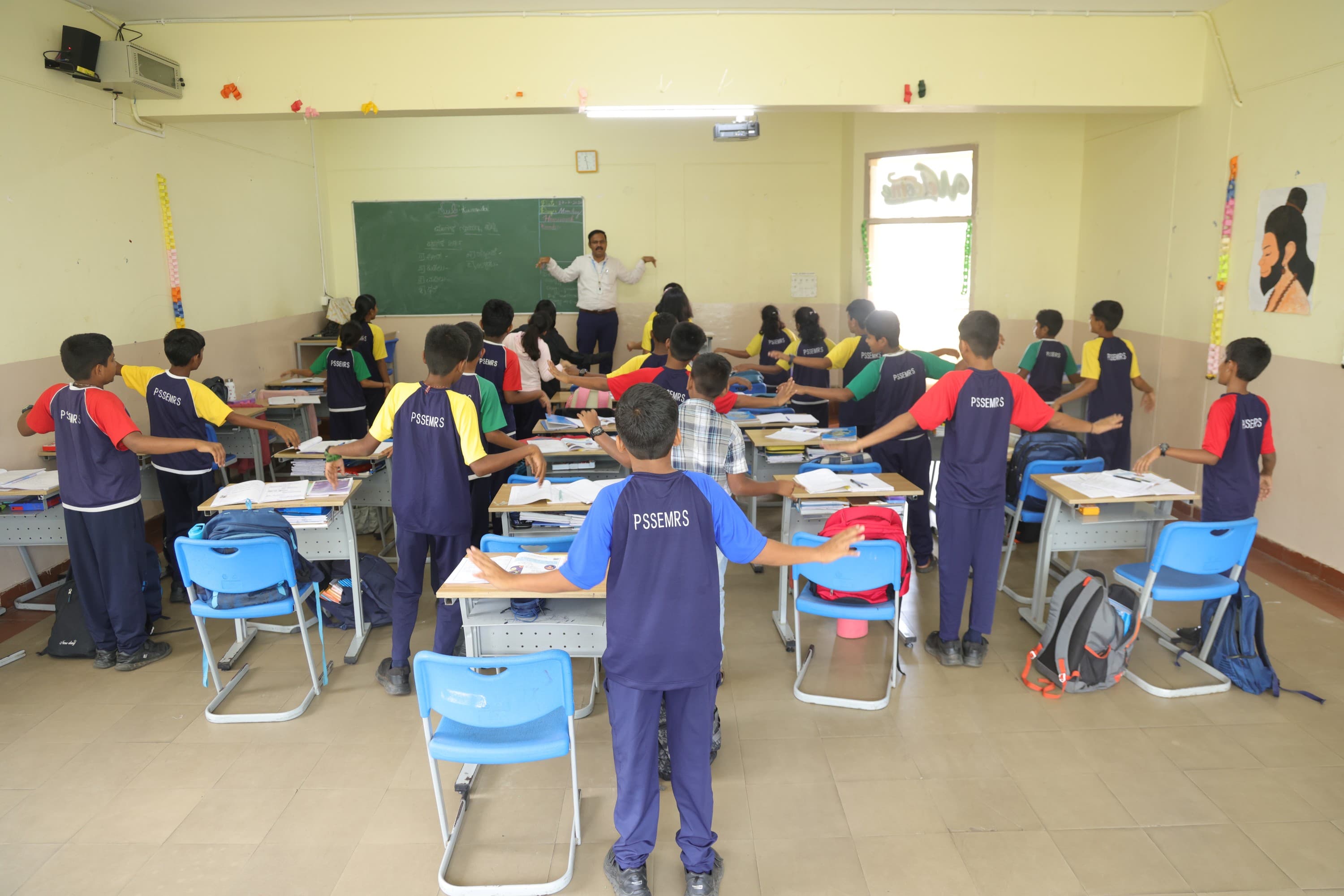A teacher working with a small group of Cambridge learners